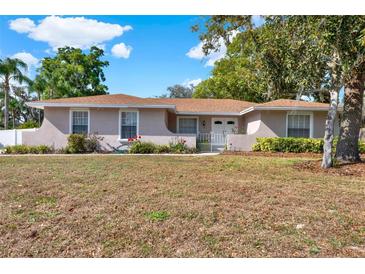 Charming single-story home featuring a well-maintained lawn and mature trees on a sunny day at 650 Sweetbriar Br, Longwood, FL 32750