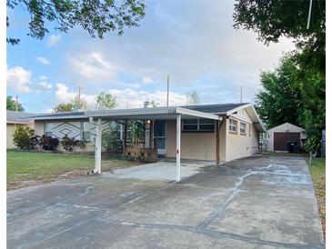 Charming single-story home featuring a covered carport and well-maintained front yard at 1118 Arrowsmith Ave, Orlando, FL 32809