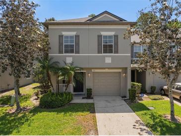 Charming two-story home with a well-manicured lawn and attached one car garage at 131 Heritage Park St, Winter Springs, FL 32708