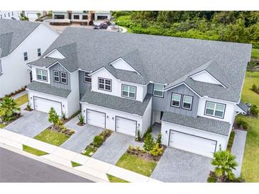 An aerial view displays these modern townhomes with two-car garages and manicured landscaping at 1438 Brookdale Ct, Oviedo, FL 32765