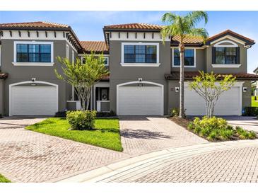 Charming townhome featuring a tile roof, two car garage and landscaped front yard at 1561 Corkery Ct, Winter Springs, FL 32708