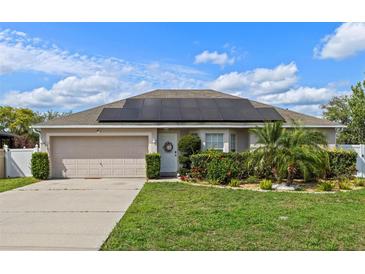 Charming single Gathering home featuring solar panels, well-maintained landscaping, and a two-car garage at 1942 N Portillo Dr, Deltona, FL 32738