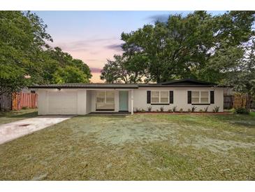 Charming single-story home featuring a well-manicured front yard and a welcoming light blue front door at 2015 N Hastings St, Orlando, FL 32808
