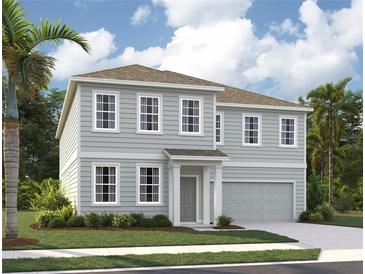 Charming two-story home with a gray exterior, manicured landscaping and a two car garage at 2286 Broadbrook Dr, St Cloud, FL 34771