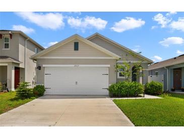 Charming single-Gathering home featuring a two-car garage and well-maintained front lawn at 2827 Turnstone Run, Harmony, FL 34773