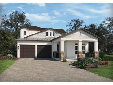Charming two-story home featuring a two-car garage, covered porch, and professionally landscaped yard at 5302 Citrus Leaf Blvd, Winter Garden, FL 34787