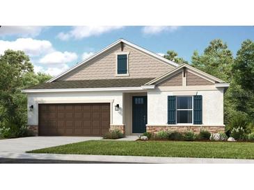 Charming one-story home with a two-car garage, stucco siding, shutters, and manicured landscaping at 545 Moon Shell Cir, New Smyrna Beach, FL 32168