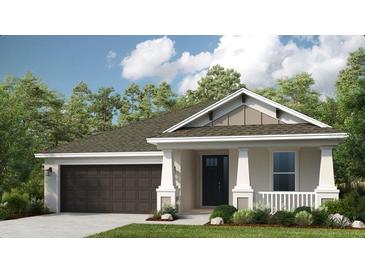 Charming single-story home with a gray and white exterior, manicured lawn, and attached two-car garage at 556 Moon Shell Cir, New Smyrna Beach, FL 32168