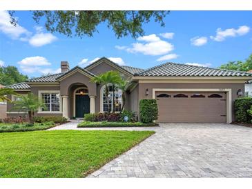 Charming home features a tile roof, manicured lawn and two car garage at 7672 Torino Ct, Orlando, FL 32835