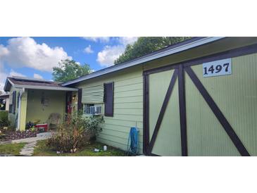 Charming single-story home featuring a unique exterior design and inviting front porch at 1497 N Normandy Blvd, Deltona, FL 32725
