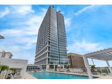 Modern high rise condo building with pool deck and clear blue skies in a desirable city location at 150 E Robinson St # 409, Orlando, FL 32801