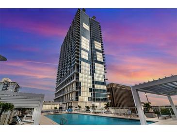 Luxury condominium rooftop pool with stunning city views and lounge seating, perfect for relaxation at 150 E Robinson St # 409, Orlando, FL 32801