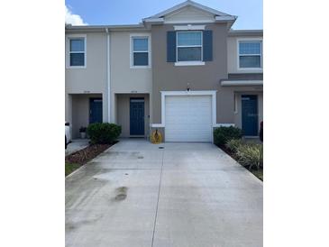 Charming townhome with an attached garage and a lengthy driveway for ample parking at 2232 Tay Wes Dr, St Cloud, FL 34771