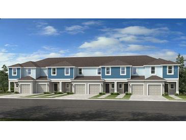Beautiful new construction townhomes with attached garages and manicured landscaping at 2592 Penguin Blvd, Davenport, FL 33837
