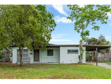 Charming single-story home with a well-maintained lawn and mature trees providing ample shade at 2827 Sanka Dr, Orlando, FL 32826