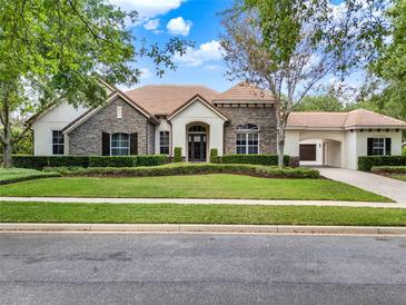 Beautiful single Gathering home with stone accents, manicured lawn, arched entry and a three car garage at 32613 View Haven Ln, Sorrento, FL 32776