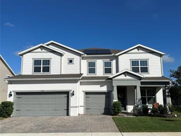 Inviting two-story home with a gray two-car garage and well-maintained landscaping and gray trim at 3399 Buoy Cir, Winter Garden, FL 34787