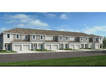 Charming townhomes with attached garages, green grass, and lovely landscaping at 3527 Mayfair St, Kissimmee, FL 34758