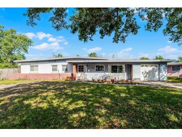 Charming single-story home with a well-maintained front yard, attached garage, and inviting entrance at 5402 Kingswood Dr, Orlando, FL 32810