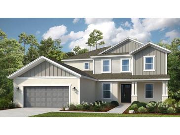 Charming two-story home showcasing a covered entry, neutral color palette, and a well-maintained lawn at 853 Junonia Blvd, New Smyrna Beach, FL 32168
