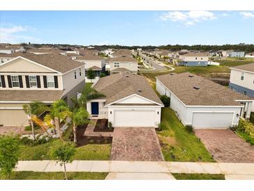 Charming single-story home with a brick driveway and well-manicured landscaping at 1580 Eucalyptus Way, Davenport, FL 33837