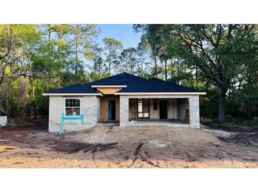 New construction home with block walls, a new roof, and a two-car garage at 2132 Pine Meadows Golf Course Rd, Eustis, FL 32726