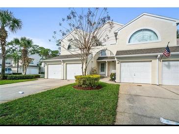 Inviting townhome with attached one-car garage, and well-manicured front lawn at 5999 Lake Pointe Dr # 602, Orlando, FL 32822