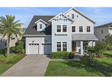 Charming two-story home with a well-manicured lawn and three-car garage at 8638 Finsen St, Orlando, FL 32827