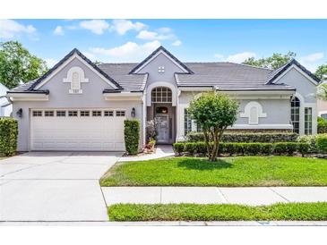 Charming single-story home with a gray exterior, manicured lawn, and well-kept landscaping at 131 Wimbledon Cir, Lake Mary, FL 32746