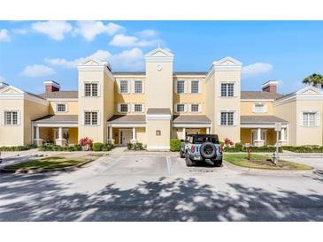 Charming building exterior with well-maintained landscaping and convenient parking at 1322 Seven Eagles Ct # 301, Reunion, FL 34747