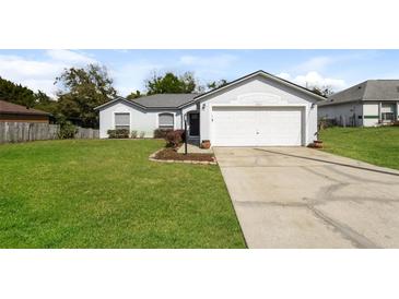 Charming single-story home featuring a well-manicured lawn and attached two-car garage at 2081 Galveston Ave, Deltona, FL 32725