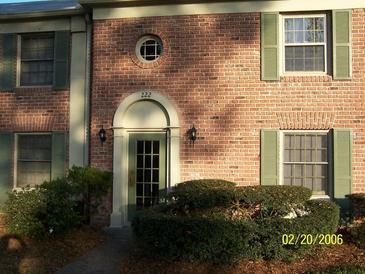 Charming townhouse with a brick facade, green shutters, and a well-maintained front entrance at 222 Georgetown Dr # C, Casselberry, FL 32707