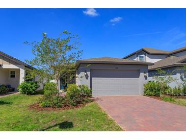 Charming single Gathering home featuring a brick paver driveway and attached two car garage at 2285 Mystic Maze Ln, Clermont, FL 34715