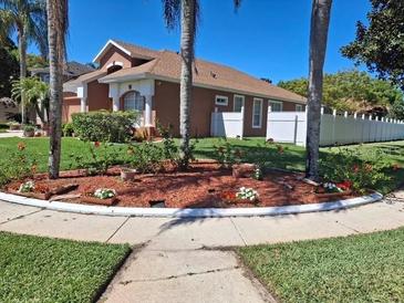 Charming single-story home featuring mature landscaping and a well-maintained lawn at 450 Morning Blossom Ln, Oviedo, FL 32765