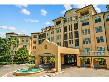 Stunning exterior view of a luxury condominium building with a beautiful fountain in the front at 501 Mirasol Cir # 519, Celebration, FL 34747