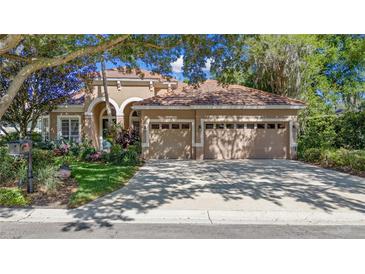 Beautiful one-story stucco home featuring a three-car garage and meticulously landscaped front yard at 1210 Pallister Ln, Lake Mary, FL 32746