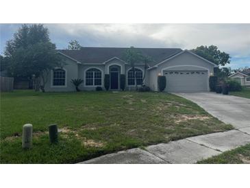 Charming single-story home featuring a well-maintained lawn and attached two-car garage at 2600 Cedar Bluff Ln, Ocoee, FL 34761