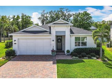 Charming single-story home featuring a well-manicured lawn, brick driveway, and a 2-car garage at 3631 Arbordale Loop, Sanford, FL 32771