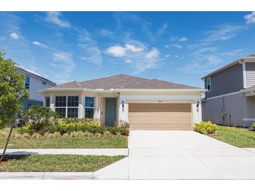 Charming single-Gathering home featuring a two-car garage and beautifully landscaped front yard at 4012 Meandering Bay Dr, Apopka, FL 32712