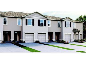 Charming townhome exterior with neutral paint, black shutters, and well-manicured landscaping at 2108 Monteverde Ave, Davenport, FL 33837