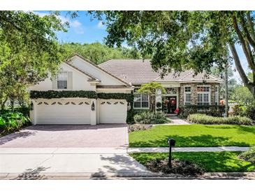 Charming two-story home with a three car garage, brick driveway, and lush landscaping at 243 Sagecrest Dr, Ocoee, FL 34761