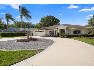 This home includes mature trees and landscaping, a circular drive, and a two car garage at 26901 Racquet Cir, Leesburg, FL 34748