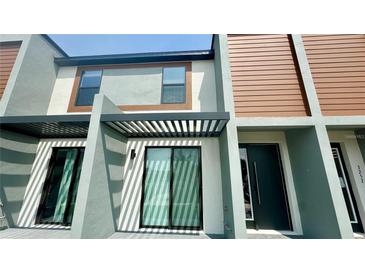 Modern townhome showcasing clean lines, pergola, and unique architectural design at 3259 Energy Dr, Kissimmee, FL 34747