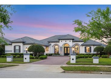 Elegant one-story home featuring manicured landscaping, brick driveway and neutral paint scheme at 3382 Fernlake Pl, Longwood, FL 32779