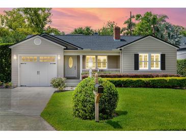 Charming home with manicured lawn, mailbox, front-facing garage, and a warm, inviting ambiance at sunset at 3514 Golfview Blvd, Orlando, FL 32804