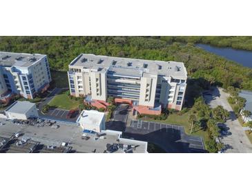 An aerial shot captures this condominium community with its lush landscaping and ample parking at 5300 S Atlantic Ave # 4-302, New Smyrna Beach, FL 32169