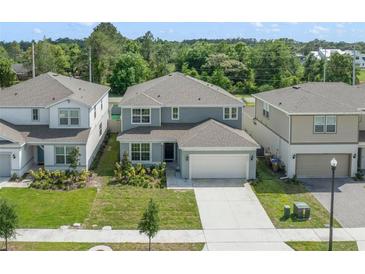 Charming two-story home with a spacious driveway and manicured landscaping at 5660 Oak Knoll Dr, St Cloud, FL 34771