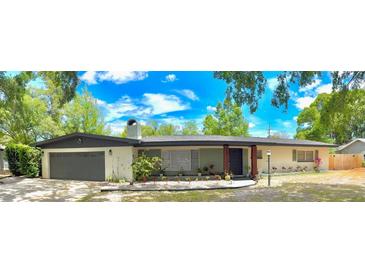 Charming single-story home with a spacious front yard and attached two-car garage at 605 Ensenada Dr, Orlando, FL 32825
