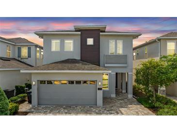 Charming two-story home with a well-manicured lawn and a modern architectural design at 7759 Westland Dr, Kissimmee, FL 34747