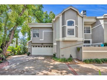 Charming two-story townhouse featuring an attached garage and mature landscaping at 796 Mcintyre Ave, Winter Park, FL 32789
